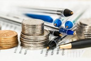 coins and pens on tax forms