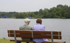 retired couple sitting on a bench