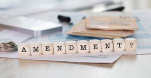 Word AMENDMENT composed of wooden letters. Closeup