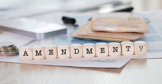 Word AMENDMENT composed of wooden letters. Closeup