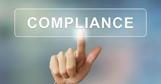 business hand pushing compliance button on blurred background