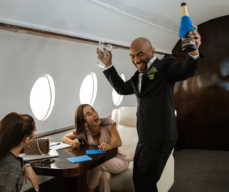 high income earners high income earners celebrating in a private plane with champagne and two ladies