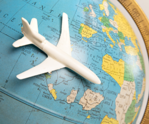 Toy plane on a globe to represent international business