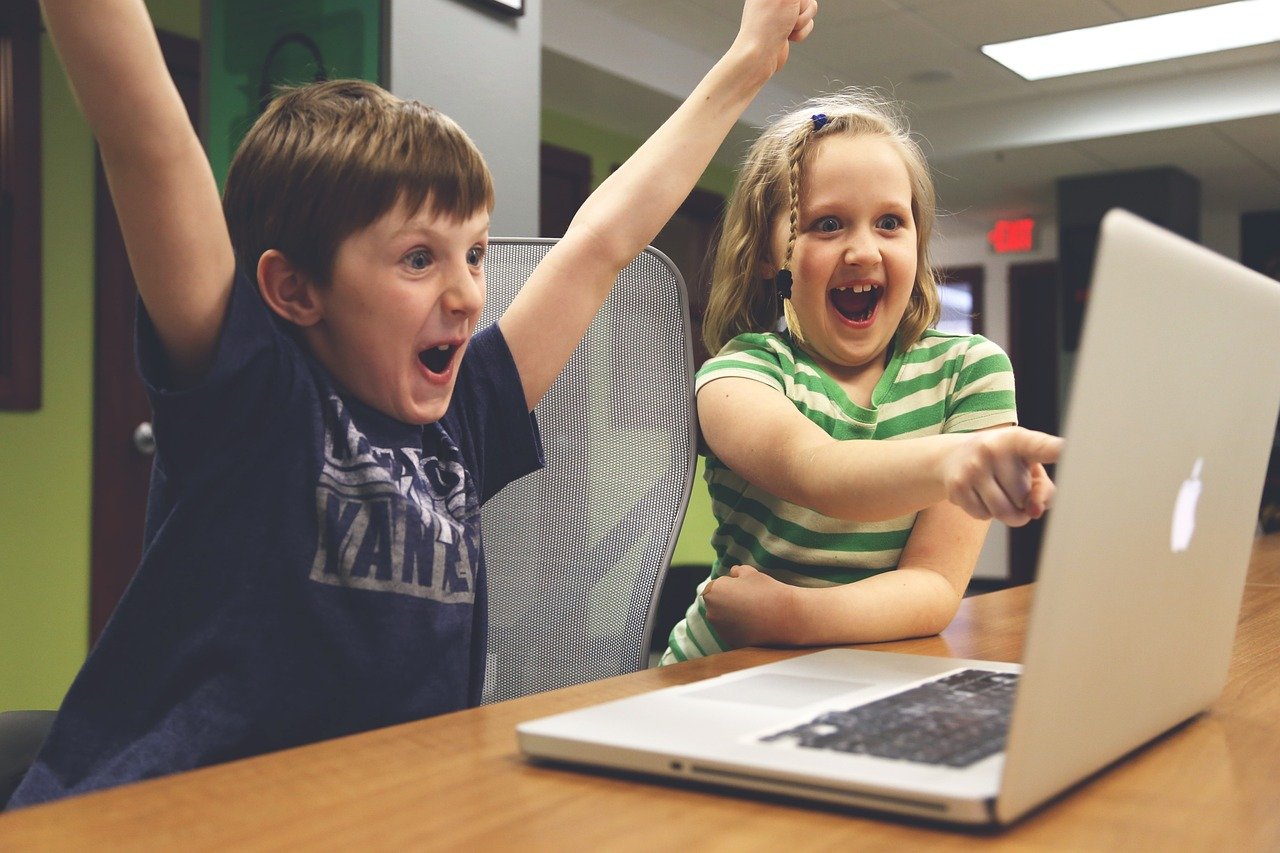 children working on a laptop