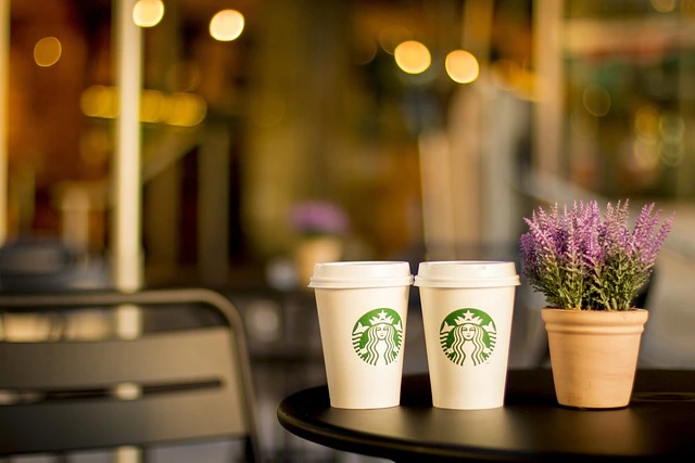 starbucks cup on cafe table to represent franchise business