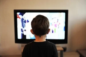 child watching an animated program on television
