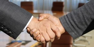 trader and professional shaking hands