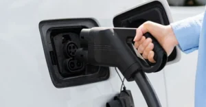 man charging his electric car