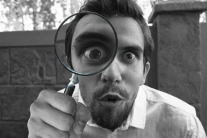 Home Inspector looking into a magnifying glass