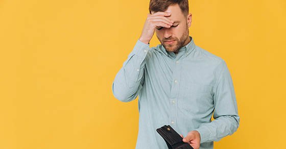 I’m,Broke.,Portrait,Of,Sad,Unshaven,Male,Bankrupt,Showing,His anxious man looking at his wallet
