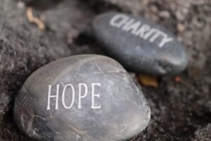 hope and charity carved on stone