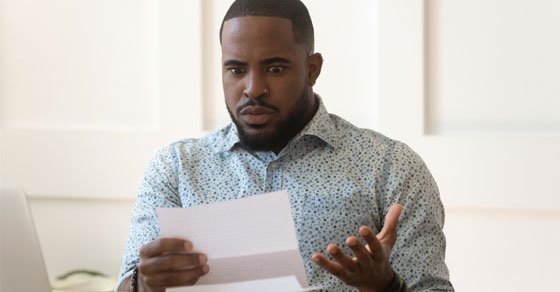 person worried looking at an audit notice person worried looking at an audit notice