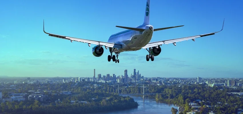airplane in the skies above a city