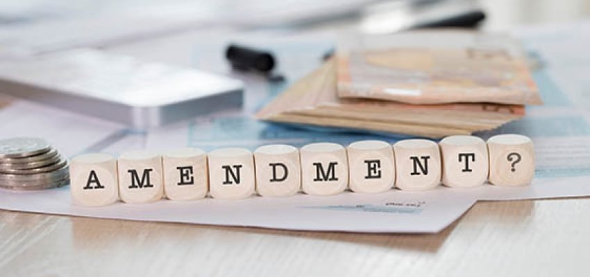 Word AMENDMENT composed of wooden letters. Closeup