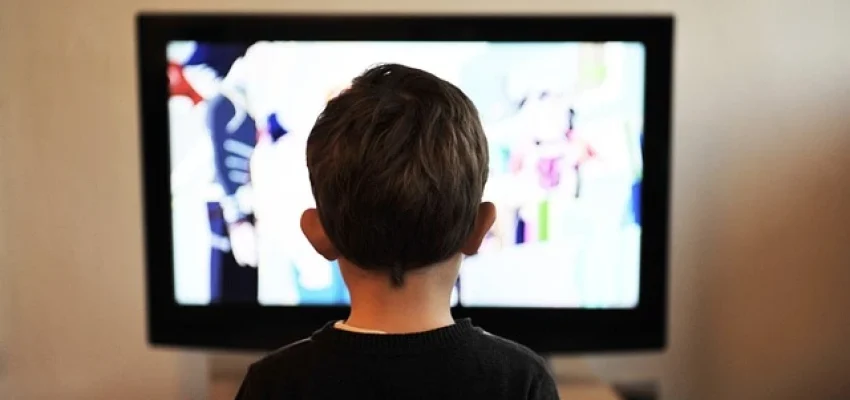 child watching an animated program on television
