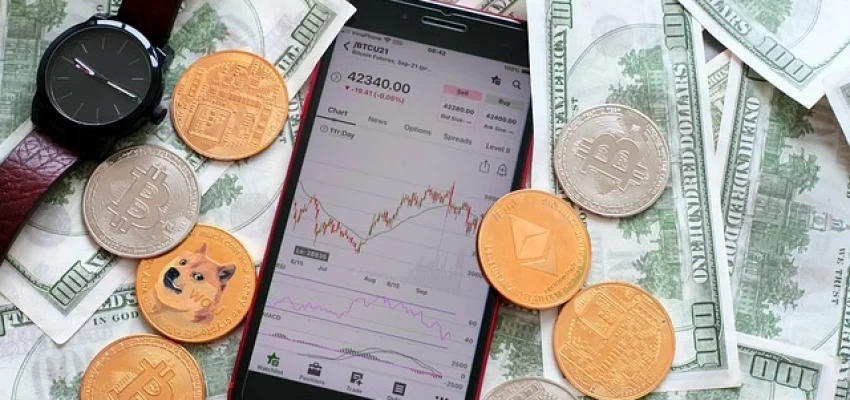 cryptocurrency trading showing a mobile phone with candlestick charts and fiat cash around along with crypto coins