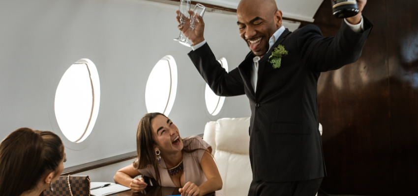 high income earners celebrating in a private plane with champagne and two ladies