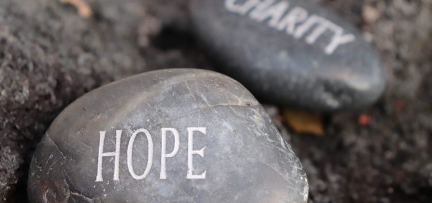 hope and charity carved on stone