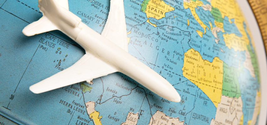 Toy plane on a globe to represent international business