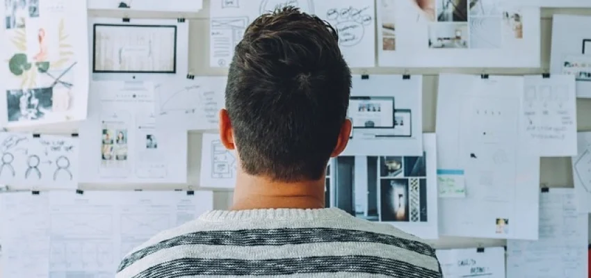 man-looking-at-his-whiteboard-for-steps-on-how-to-start-his-company