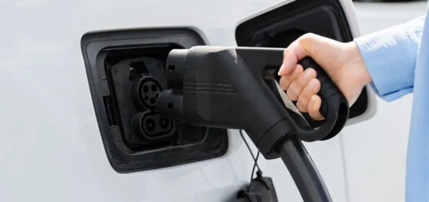 man charging his electric car