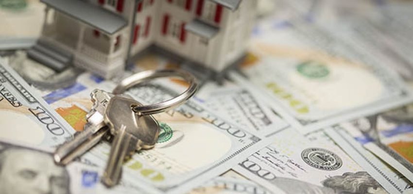 Small Model House and Keys on Newly Designed U.S. One Hundred Dollar Bills.