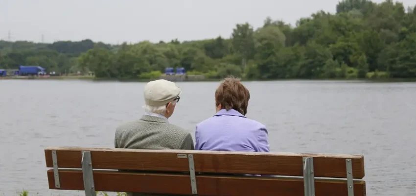 retired couple sitting on a bench