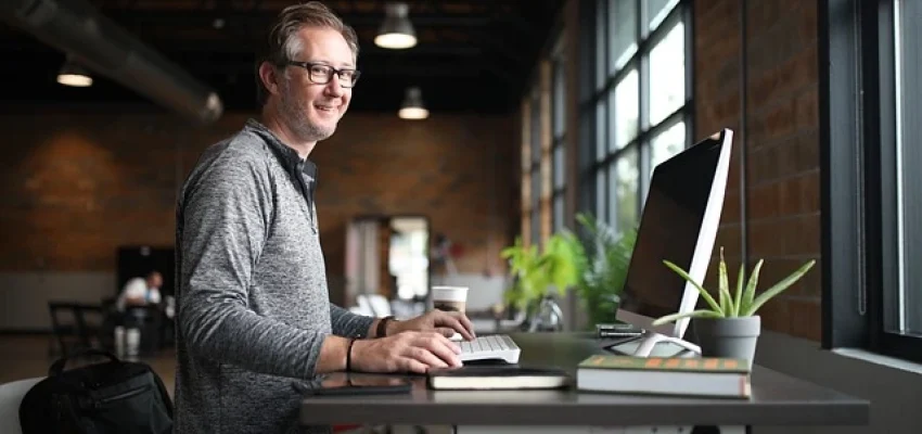 small business owner sitting at a desk with a laptop
