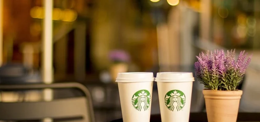 starbucks cup on cafe table to represent franchise business
