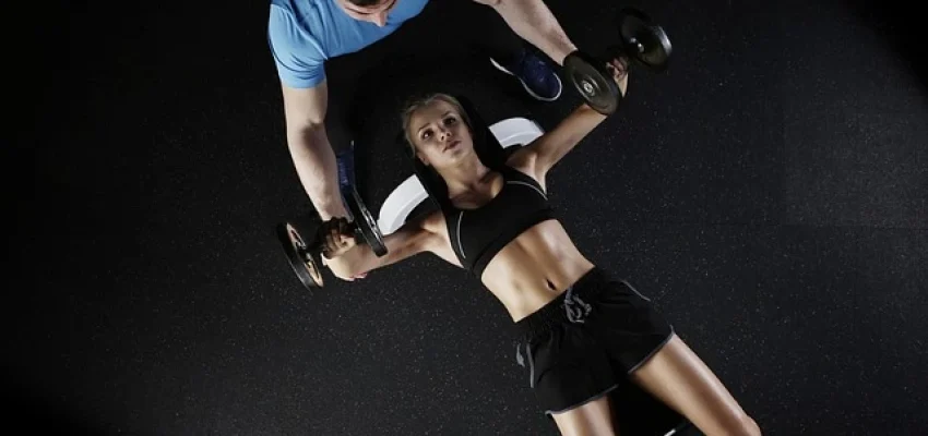 woman-with-a-personal-trainer-at-a-fitness-center